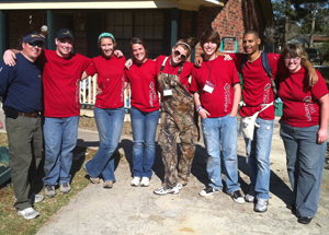 Tri County Roofing employee pictured with teens at an event.