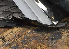A storm damaged roof with damaged decking board in Charleston, South Carolina