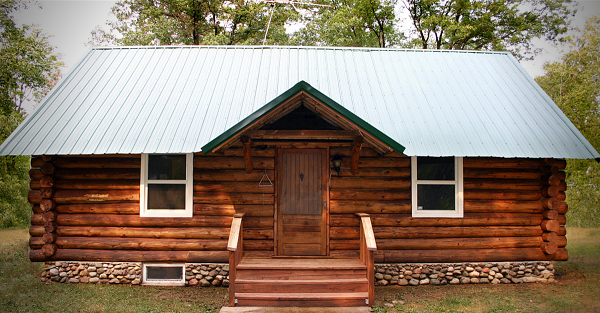 cute log home with metal roofing